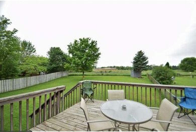Deck view overlooking fenced back yard