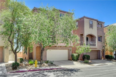 View of front of home with a garage, stucco siding