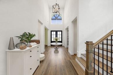 A soaring two-story entryway welcomes you with abu
