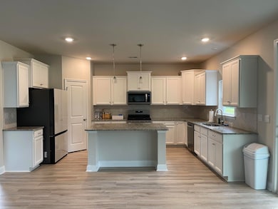 Kitchen featuring white cabinets, sink, a kitchen 