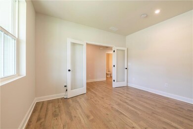 Unfurnished room with french doors and light wood-