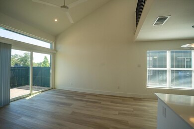 Unfurnished room with high vaulted ceiling, a cei