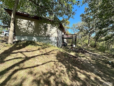 View of property exterior with a wooden deck