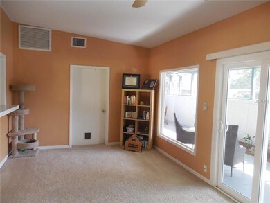 Family room; door leads to laundry/workshop and storage room; lots of windows
