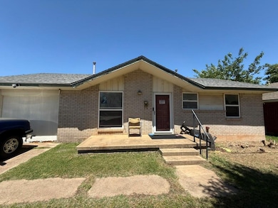 View of front of home featuring brick siding, a garage, a shingled roof, and a front lawn