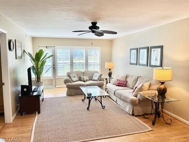 Living area with light wood finished floors and a ceiling fan