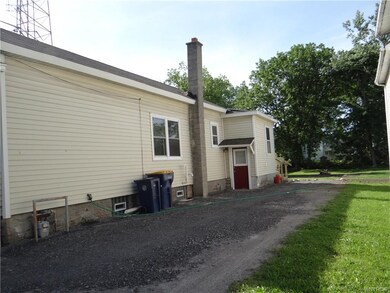 Large stone driveway for parking vehicles. Side entrance can take you into the mud room or the basement.
