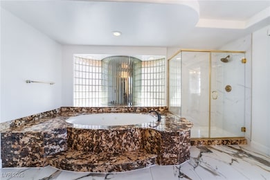 Full bath featuring a marble finish shower, a gard