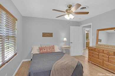Primary suite featuring blinds and ceiling fan.