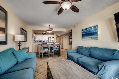 Tiled living room featuring a textured ceiling and