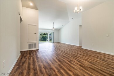 Unfurnished living room with dark wood-style floor
