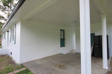 Carport with concrete surface and 6x10 storage