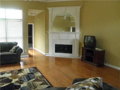 Gas fireplace in living room.  Hallway leads to pr