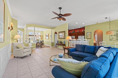 Living room featuring arched walkways, a ceiling f