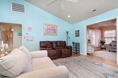 Living area with baseboards, a ceiling fan, visibl
