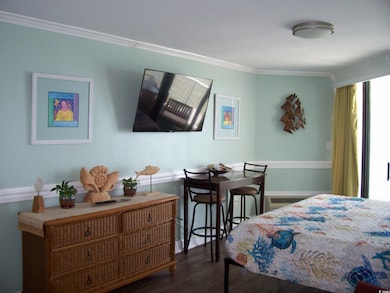 Bedroom featuring crown molding and wood finished 