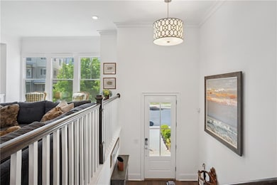 Foyer entrance featuring ornamental molding, dark 
