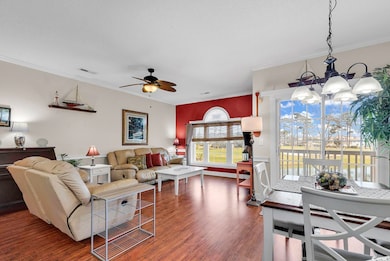 Living room featuring visible vents, dark wood fin