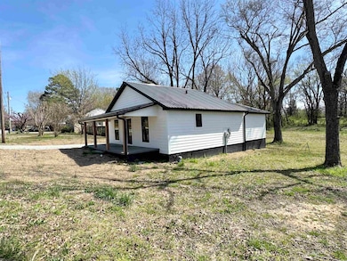 View of side of property featuring covered porch a