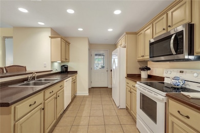 spacious galley kitchen, door leads to single garage