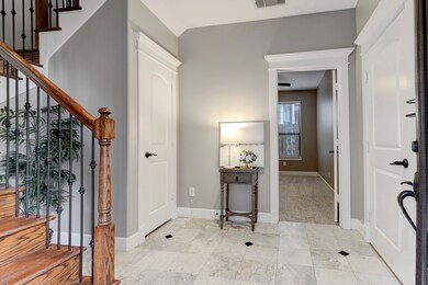 Upon entry, is an elegant foyer with an oversized