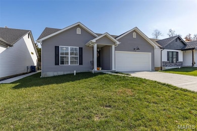 Ranch-style house with driveway, a front yard, and an attached garage