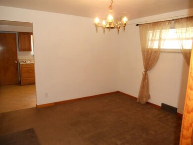 Dining Room with carpet looking into Kitchen
