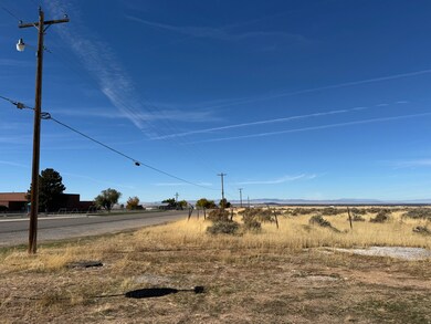 View of asphalt street featuring a view of rural / pastoral area