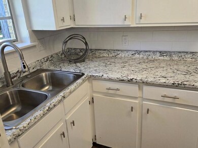 Kitchen features a new stainless steel sink and fa