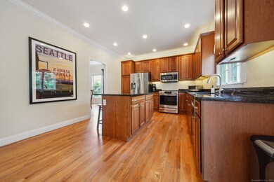 Entertaining is a breeze in the large kitchen with granite counters, stainless appliances, island, large dining area and grand family room with sliders to continue your entertaining on the deck.