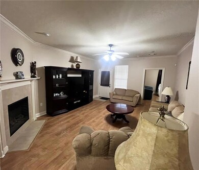 LIVING ROOM WITH CORNER WOOD BURNING FIREPLACE/MAN