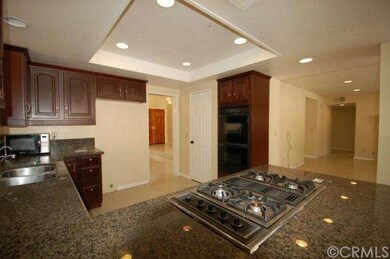 Kitchen showing granite counters and gas cooktop