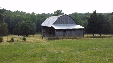 Great Barn with separate fenced area towards the back, creek and level area for a riding ring