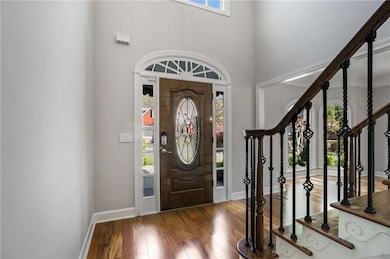 Entrance foyer with stairway, wood-type flooring, 