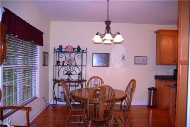 The breakfast area just off of the kitchen features hardwood floors.
