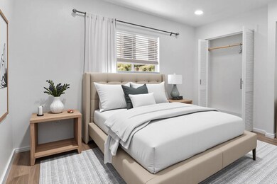 Bedroom with wood finished floors, baseboards, re