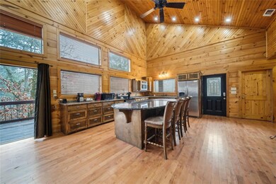 Kitchen with a kitchen island, wooden walls, stain
