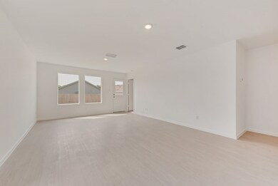 Empty room with light wood finished floors and recessed lighting