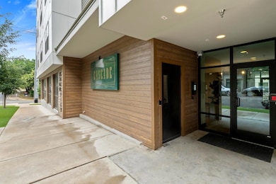 Doorway to property with elevator and a patio area