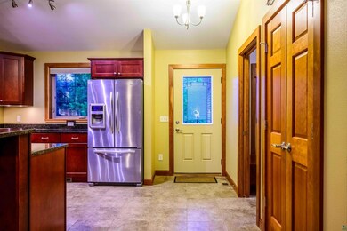 Kitchen featuring stainless steel fridge with ice 