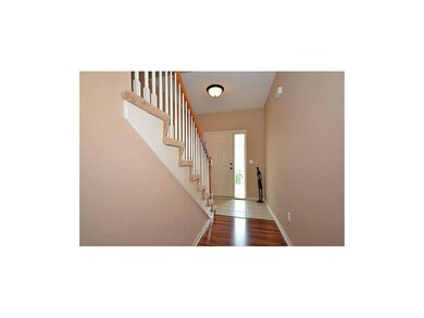 OPEN FOYER INVITES YOU IN THIS TWO-STORY HOME.