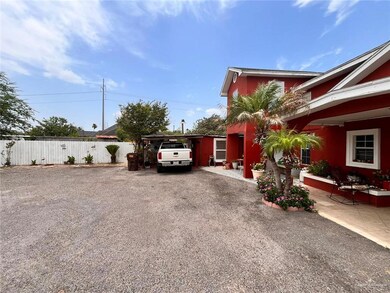 View of side of property with driveway and a carport