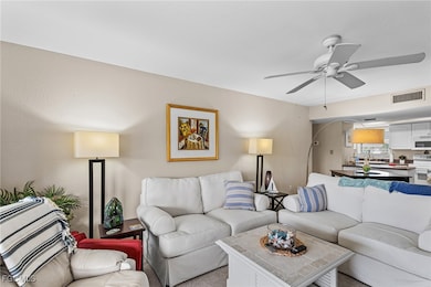 Living area featuring a ceiling fan and arched walkways