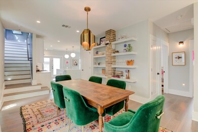 Dining area with wood finished floors, stairway, 