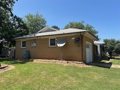 View of property exterior featuring a yard