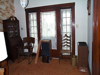 The entry shows the original wood trim and grand d
