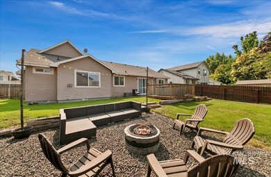 Back of house with a fire pit, a fenced backyard, and a wooden deck