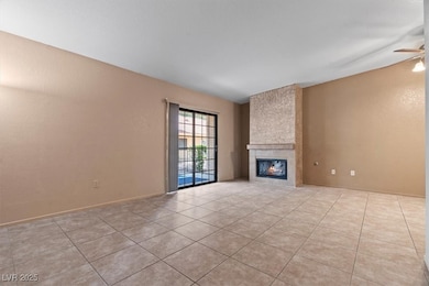 Unfurnished living room featuring ceiling fan, a l
