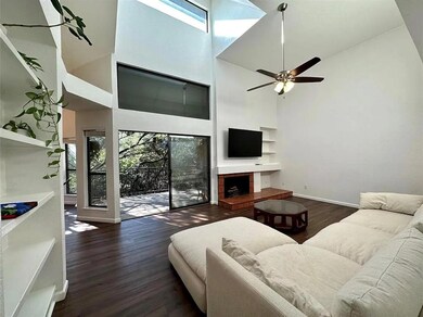 Living area with a towering ceiling, wood finishe