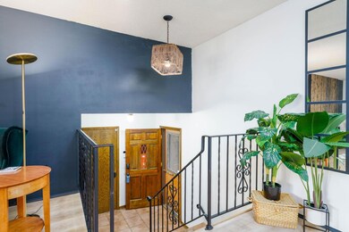 Looking down from living room, you can see the size of the foyer which also leads to attached two car garage.